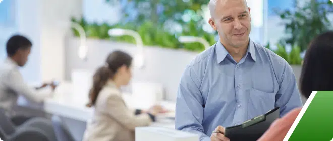 Man speaking to a woman with two other women in the background