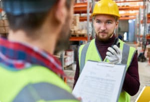 Young Worker Talking to Supervisor in Warehouse