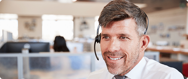 Man in an office wearing a headset