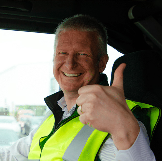 man giving a thumbs up in a truck